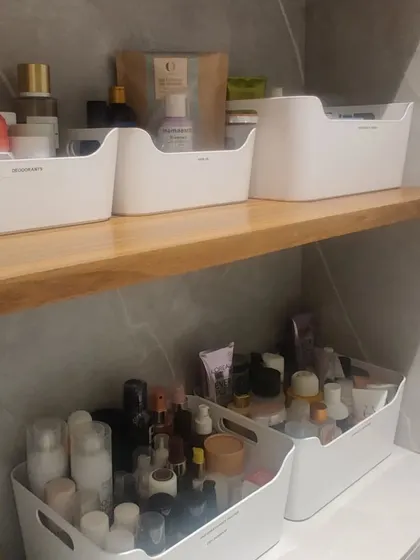 Bathroom toiletries can be easily organized using simple white bins. We created separate bins for skincare and other essentials, keeping the shelves and counters tidy and clutter-free.