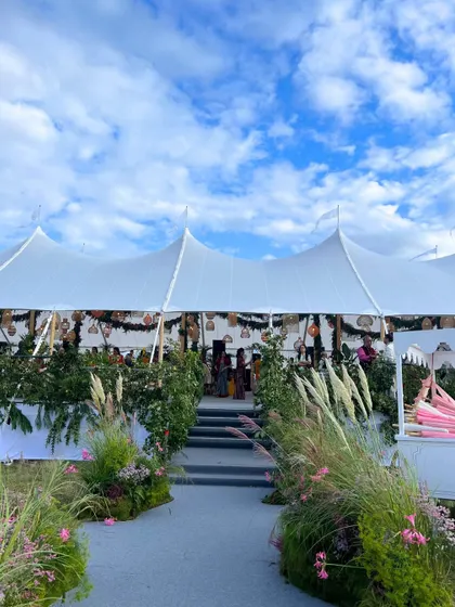 The entrance to a beautiful marquee tent in the English countryside. We work with top international partners to build stunning temporary structures that feel both grand and intimate.