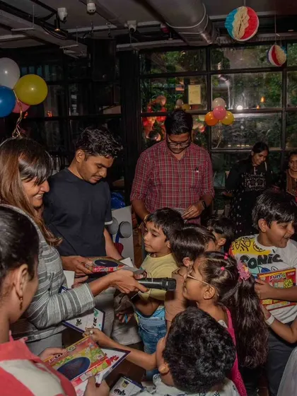 It's all smiles as children gather to receive their certificates and prizes, celebrating a birthday filled with discovery and achievement.