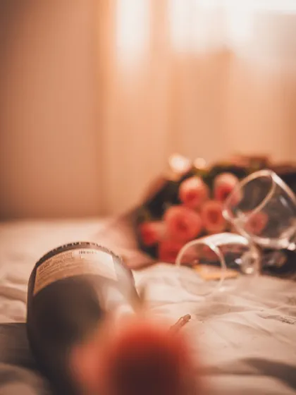 A creative, artistic shot of the wine bottle and glasses, using blur and perspective to evoke a dreamy, intimate feeling.