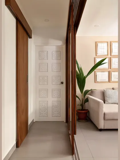 The beautifully restored solid wood doors, painted in a matte white to create a juxtaposition with the minimal woodwork. The corridor wall was also replaced with sliding glass doors to open up the space.