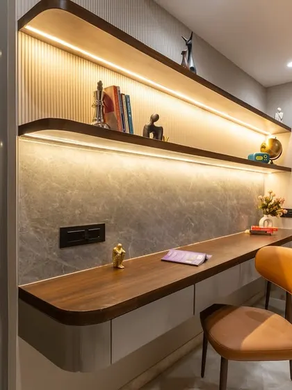 This custom study zone blends form with finesse. A warm walnut-toned worktop with rounded edges, subtle fluting, and soft grey stone textures set the tone for a space that inspires focus without compromising on style.