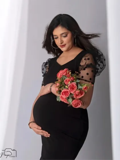 A beautiful and serene solo portrait. The flowers add a soft, romantic touch to the modern and chic black dress.