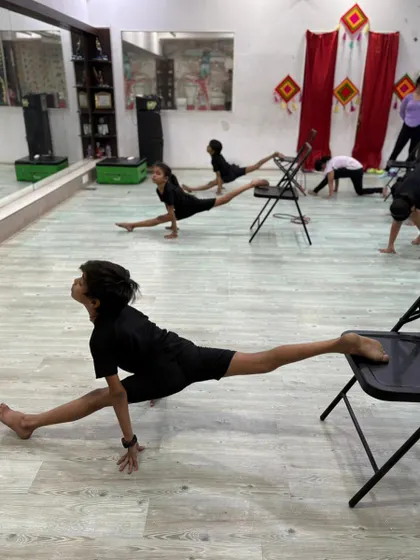 Another angle of our students practicing their splits. The mirror in our studio helps dancers check their alignment and posture.