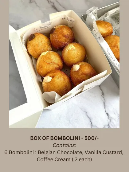 A box of my freshly made bombolini is a delightful gift for Rakhi. This box includes six Italian-style doughnuts filled with three different creams: Belgian Chocolate, Vanilla Custard, and Coffee.