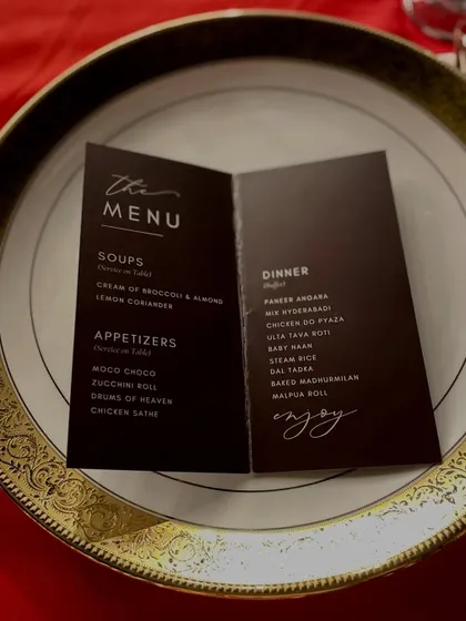 Your vision, our menu. This is an example of a custom menu card designed for a client's dinner, placed elegantly on a gold-rimmed plate.