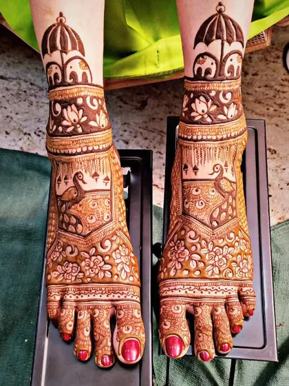Bridal mehndi isn't just for hands. This intricate foot design features cute little elephants and peacocks, ensuring the bride is adorned from head to toe.