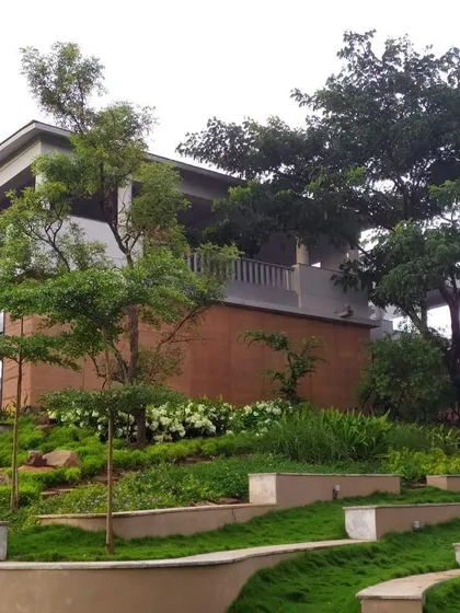 A view of a Yoga School we designed, showing how the building is nestled into a terraced, blooming landscape. The architecture is designed to be in harmony with its natural surroundings.
