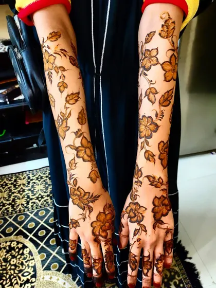 The full view of the completed floral vine sleeves, a perfect choice for a nature-inspired henna look.