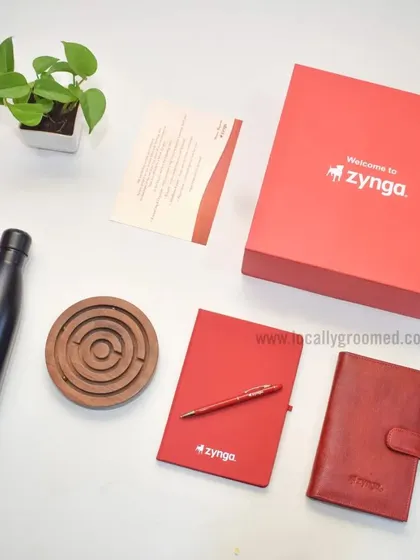Another fantastic welcome kit we created for Zynga. This one includes a branded water bottle, a red notebook and pen, a leather-style diary, and a wooden maze game for a touch of fun.