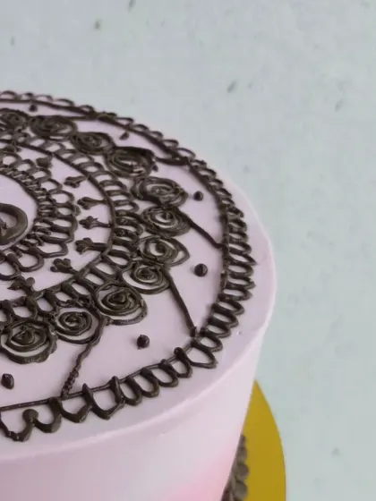 A unique Mehendi themed cake, perfect for pre-wedding celebrations. The intricate design is piped with chocolate to mimic traditional henna art.