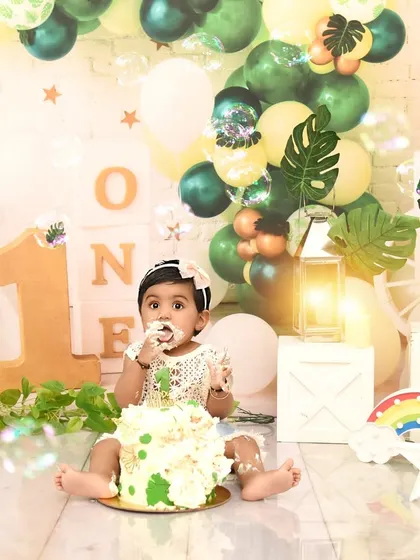 A tiny taste of birthday cake. This is the moment the fun really begins during a first birthday cake smash session.