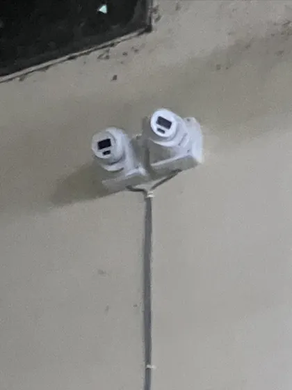 A custom dual-camera mount to monitor two directions from a single point. This is a smart solution for covering long corridors or aisles.
