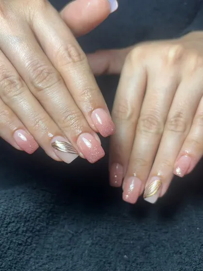 A simple and elegant set of square-shaped nails with a shimmery pink base and subtle gold line accents.