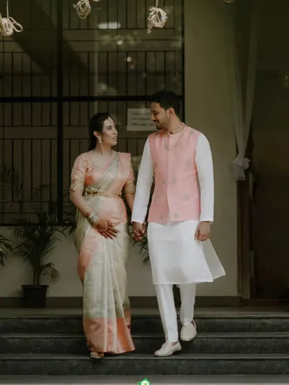 The couple is seen here walking together, showing how the coordinated outfits move. The lightweight fabrics and comfortable tailoring ensure you can enjoy your event without feeling restricted.
