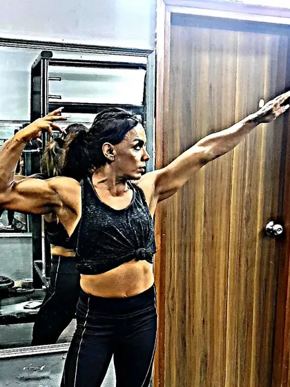 A dramatic pose showing off my arm and back muscles. Bodybuilding is an art form.