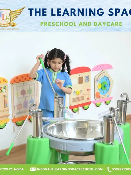A young girl plays a large steel drum instrument. Our music area is designed to be accessible and engaging for children of all ages, encouraging them to make some joyful noise.