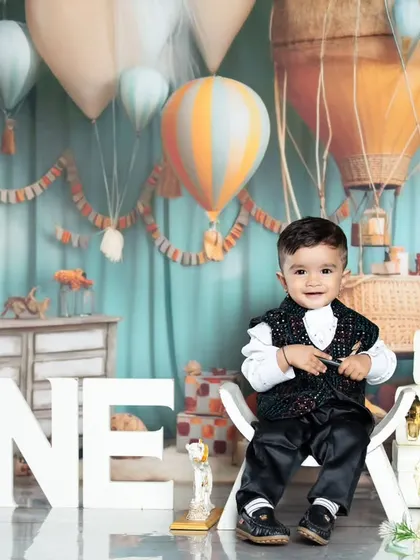 Another happy one-year-old enjoying his travel-themed birthday shoot.