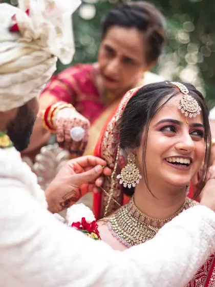 The tying of the sacred thread, a key moment in the wedding ceremony, captured with a focus on the couple's happy expressions.