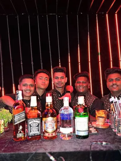 Here is our energetic team behind a vibrant LED bar. We ensure our bartenders and the bar itself match the high-energy vibe of a sangeet or after-party.