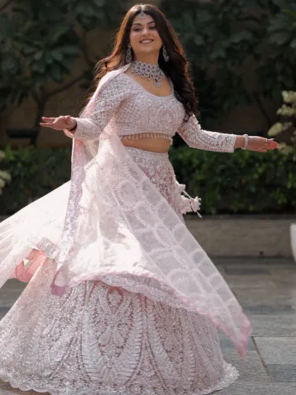A joyful and candid bridal portrait. The bride's twirl shows off the beautiful movement of her lehenga and captures her infectious happiness and free spirit.