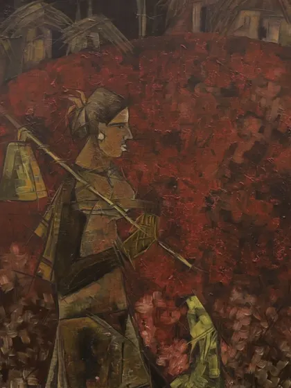 A lone figure walks amidst an earthy red backdrop in this painting by Pushpa Dravid. The piece reflects the isolation of rural life, with a striking use of deep reds and earthy tones.