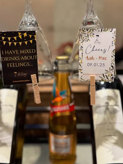 A special setup for Aish & Mec's anniversary, featuring personalized tags and a selection of fine wines.