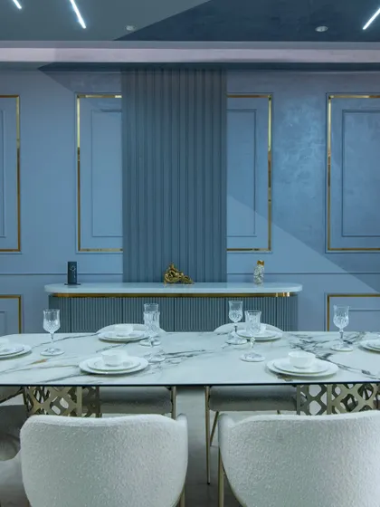 A close-up of the dining table, set against a backdrop of fluted and textured wall panels. The details add structure and interest, elevating the dining experience.
