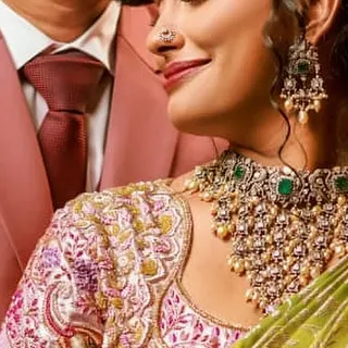 A close-up of a multi-colored blouse we created for a bride. The intricate floral and paisley patterns are brought to life with Zardozi work, showing how we can create a rich tapestry of colors on fabric.