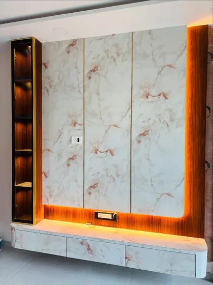 A straight-on view of the marble TV unit, highlighting the warm backlighting that frames the entire setup.