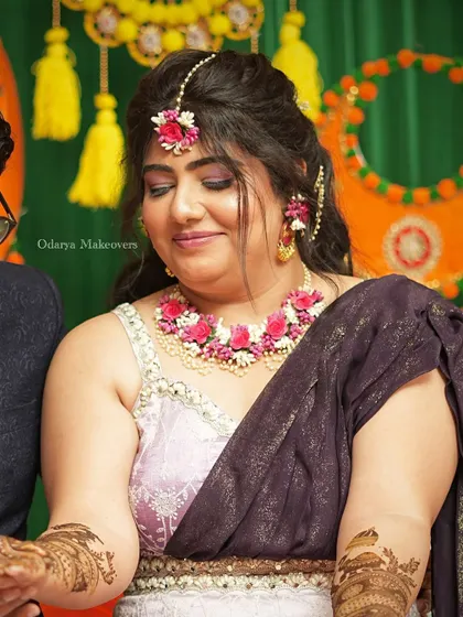 A beautiful Mehendi look featuring a soft purple smokey eye and floral jewellery. The makeup is glamorous enough for photos but still comfortable for the long hours of the ceremony.