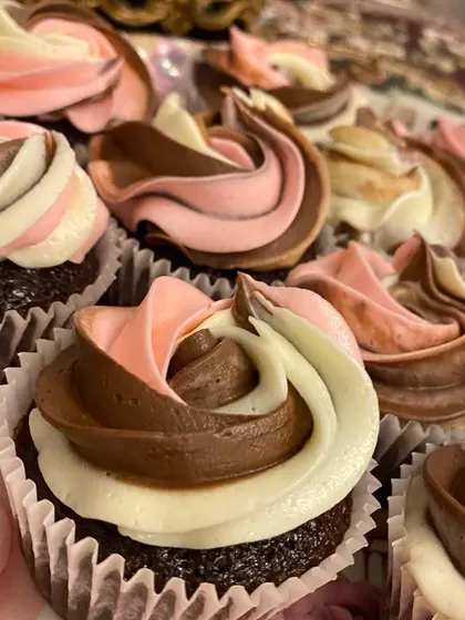 My moist chocolate cupcakes with a beautiful swirl of vanilla, chocolate, and pink frosting. They are a treat for the eyes and the taste buds.