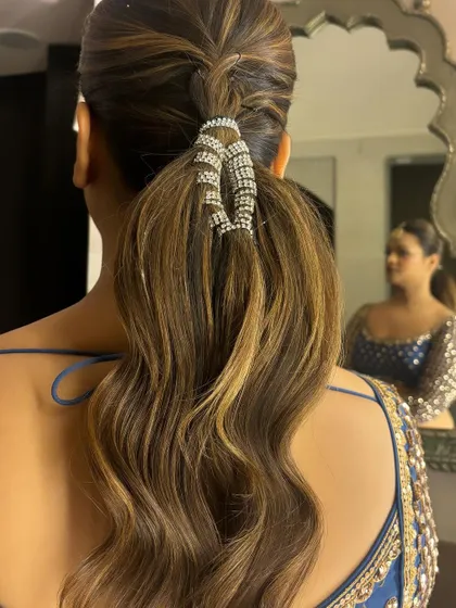 Another angle of the crystal-wrapped ponytail, showing how it catches the light. This is a great example of a glamorous yet understated hairstyle for an evening event.