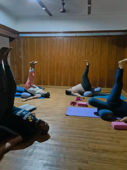 This weekend, relax and rejuvenate. Students resting in a supported legs-up-the-wall pose, using bolsters to create a feeling of bliss and ease.