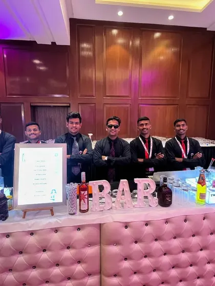 The full team behind our elegant tufted bar at a corporate conference. We present a united, professional front for your event.
