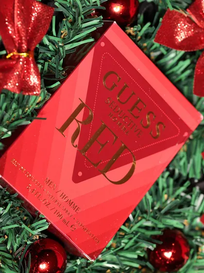 A close-up on the Guess Seductive Red perfume, a bold and masculine gift choice for the holidays.