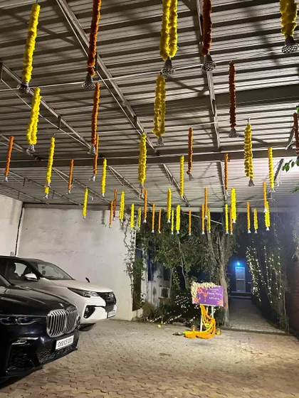 Even the parking area can be made festive. We decorated the ceiling of this carport with hanging marigold strings for a Diwali party.