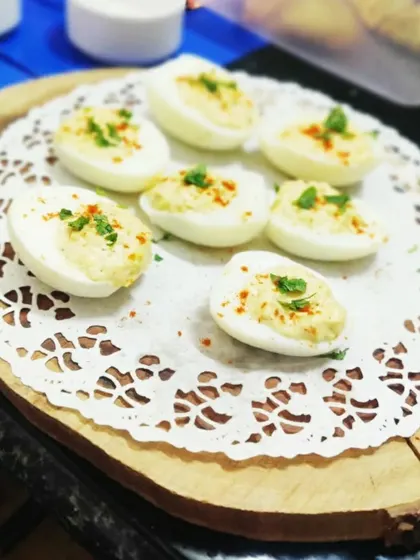 Deviled eggs are a classic and elegant appetizer. We prepare the yolk filling with a creamy blend of spices and garnish them simply for a clean presentation.