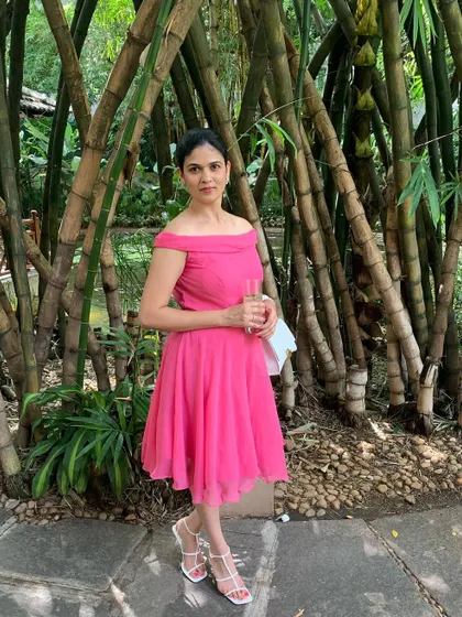 Another shot of the custom pink off-shoulder dress. The fit-and-flare style is universally flattering, and the lightweight fabric makes it comfortable for any celebration.