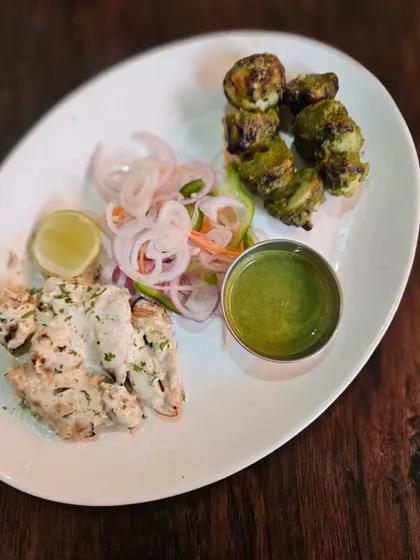 A plate featuring two of our vegetarian favourites: the creamy Malai Soya Chaap and the herby Hariyali Mushroom Tikka. Both are cooked in the tandoor and offer unique, delicious flavours.