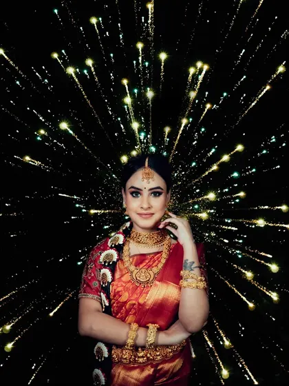 A creative bridal portrait with a firework-like explosion of light in the background, making her the star of the show.