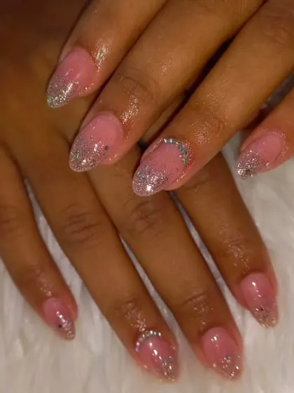 A delicate and feminine look with a sheer pink base and a sprinkle of silver glitter at the tips and cuticle.