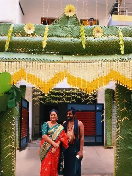 A couple posing proudly under the step chapra I created for their ceremony. These traditional entrances make for wonderful photo opportunities.