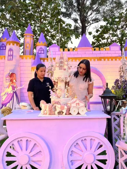 Another view of the on-site setup, making sure the princess castle cake is perfectly positioned.