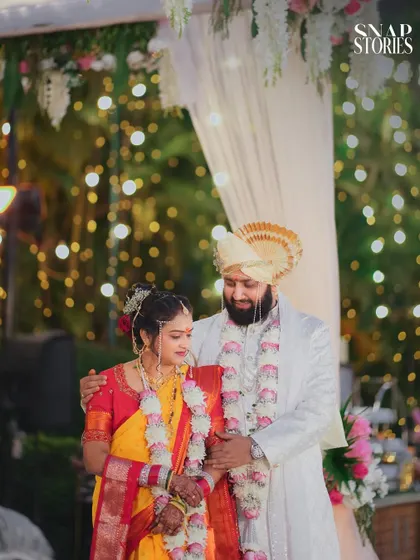 A beautiful wide shot of the couple at their evening ceremony, surrounded by soft lights. We capture both the grand scale and the intimate details of your wedding decor and ambiance.