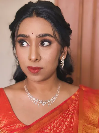 A three-quarter profile of Sirisha, showing how the makeup enhances her features for stunning wedding photos.