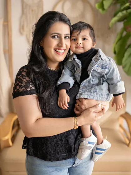 A stylish mother and son portrait. The little boy's denim jacket and the mother's lace top add a fashionable touch to this happy and loving photo.