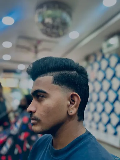 Another angle of the taper fade, showing how it cleanly connects to the styled top. This is a versatile men's haircut suitable for any occasion.