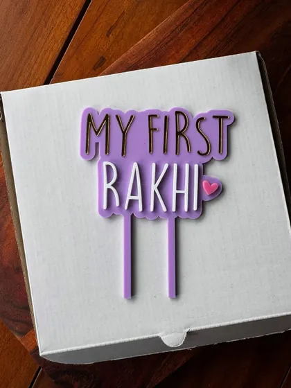 Celebrate a baby's first Rakhi with this adorable layered acrylic topper. The combination of purple, white, and gold mirror acrylic makes it a special keepsake.