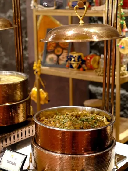 A view of our main course buffet, featuring a variety of dishes served in elegant copper chafing dishes that keep the food warm and inviting. This shows our Subz Miloni, a mix-veg specialty.